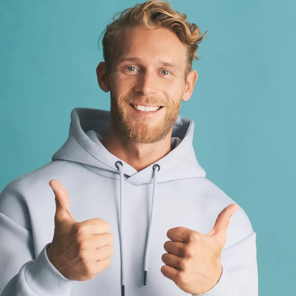Man with healthy teeth smiling and giving thumbs up