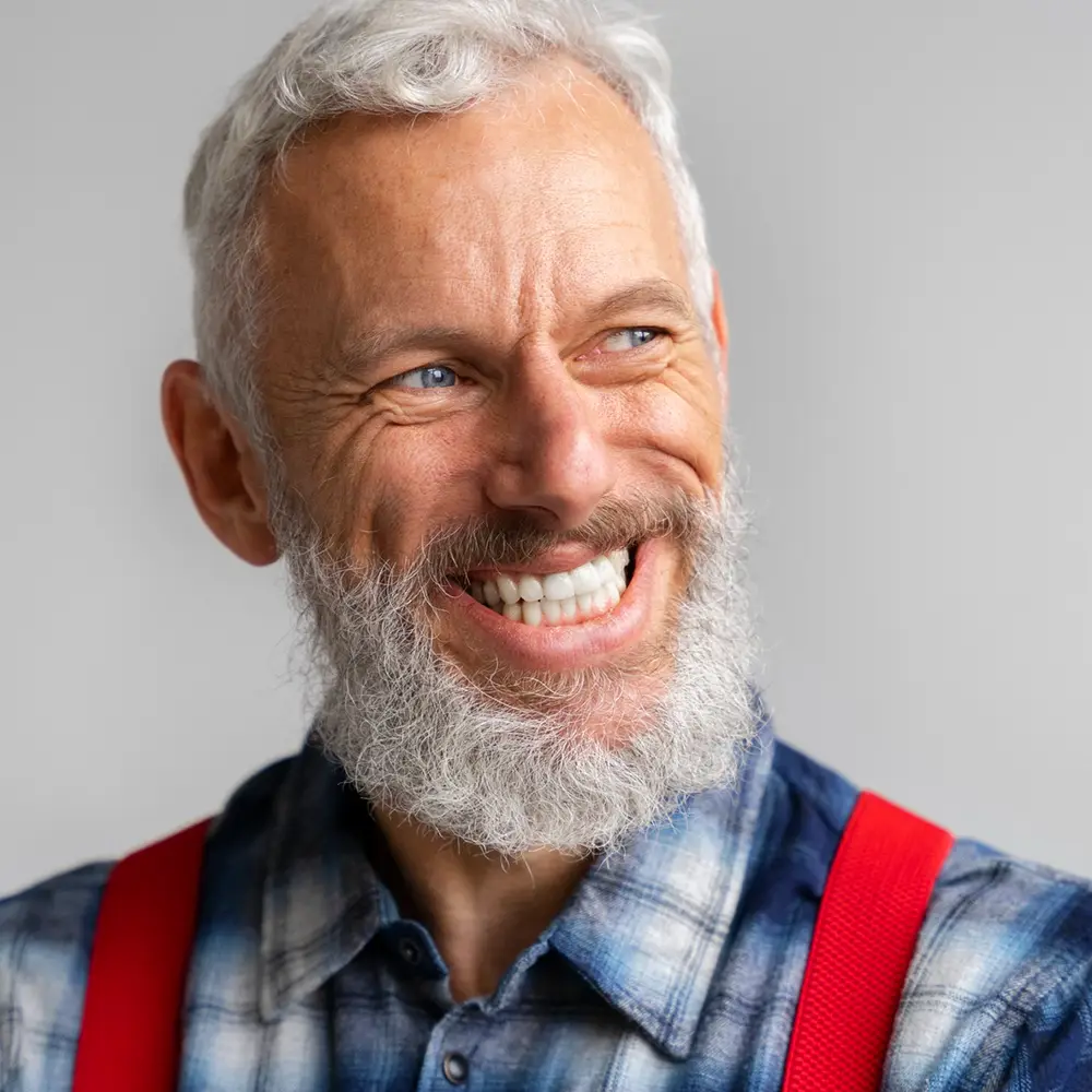 Older man smiling with nice white cosmetic teeth veneers